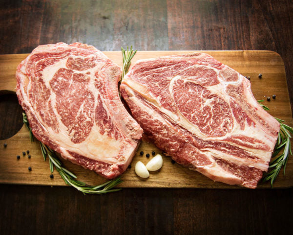 Bone-in Rib Steaks with garlic cloves and peppercorns Bennion Beef Wagyu 